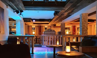 © Hotel Steinbock Eine gemütliche Bar mit Holzdekor und sanfter Beleuchtung. Die Sitzecken laden zum Entspannen ein. | © Hotel Steinbock