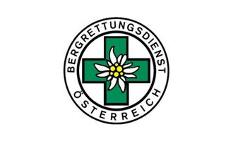 Ein Logo des Bergrettungsdienstes Österreich. Es zeigt ein grünes Kreuz mit einer Alpenblume in der Mitte. | © Bergrettung Mittelberg Hirschegg Logo