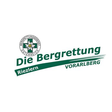 The image shows the logo of the Austrian Mountain Rescue Service. It is designed with the words "The Mountain Rescue Riezlern Vorarlberg" as well as an emblem featuring a flower. | © Bergrettung Vorarlberg
