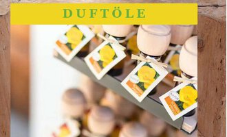 A row of shelves with fragrance oil bottles, which are equipped with wooden caps. Each bottle has a label with a yellow flower.